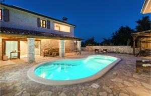 a swimming pool in front of a house at Villa Milica in Pula