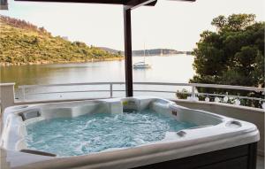 a hot tub on a balcony with a view of a river at Villa Naranca in Split +50 photos