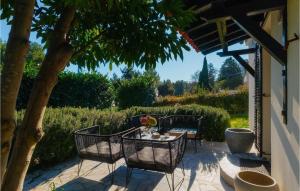 d'une terrasse avec une table, des chaises et un arbre. dans l'établissement Villa Aavaas, à Pula