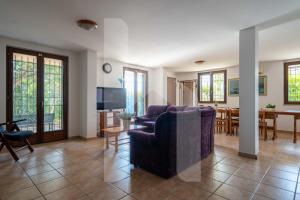 a living room with a couch and a table at Homiday - Villa Mila in Pineto