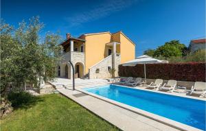 a villa with a swimming pool in front of a house at Villa Marasi in Poreč