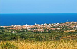 a town on a hill next to the ocean at Stunning Home In Monterotondo Marittimo in Monterotondo +23 photos