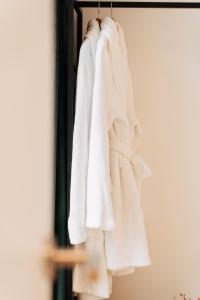 a group of white towels hanging on a rack at ZILTE STILTE in Ostend
