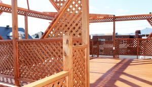 a wooden deck with a wooden gate on a balcony at Hébergement Italia in La Tuque