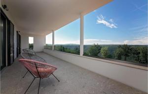 a balcony with two chairs and a view of the mountains at Villa Althea in Ružići