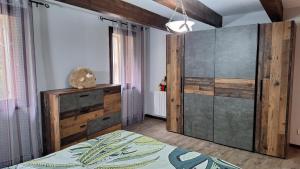 a bedroom with a bed and a large wooden cabinet at Vacances Et Weekends A Ceret in Céret