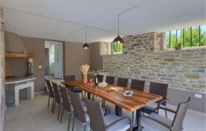 a dining room with a wooden table and chairs at Villa Zamari in Zarečje