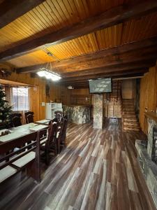 a dining room with a table and a fireplace at Опришок in Palyanytsya