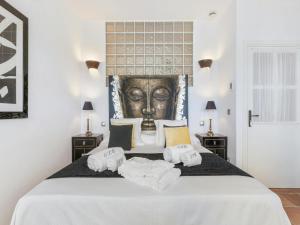 a bedroom with a bed with towels on it at Villa in Santa Gertrudis with Infinity Pool in Santa Gertrudis de Fruitera +32 photos