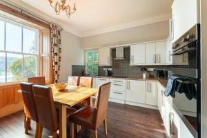 a kitchen with a wooden table and a dining room at Langdale Crag in Grasmere