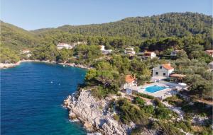 an aerial view of a house on a cliff next to the water at Holiday Home Poplat 19 in Vela Luka