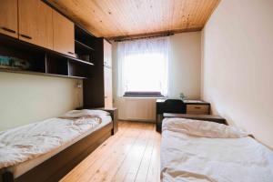 a room with two beds and a window in it at Apartment Skala with Magnificent view in Rečica ob Savinji