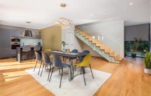 a dining room and kitchen with a table and chairs at Villa Hedone Rakalj in Krasa