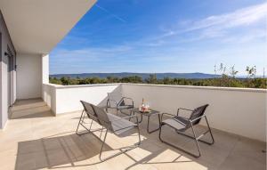 a patio with chairs and a table on a balcony at Villa Hedone Rakalj in Krasa +39 photos