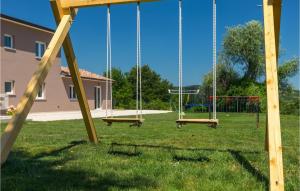 an empty playground with swings in a yard at Villa Zamari in Zarečje +52 photos