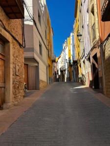 an empty street in an alley between buildings at Casa Rural EL TRULL in Canet lo Roig