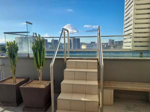 a balcony with stairs and a view of the city at City Sanctuary Trift Towers in Windhoek +16 photos