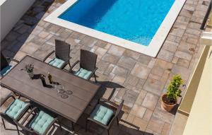 an overhead view of a table and chairs next to a swimming pool at Villa Florami in Pula