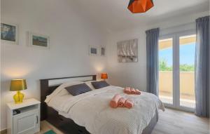 a bedroom with a bed with pink slippers on it at Villa Florami in Pula