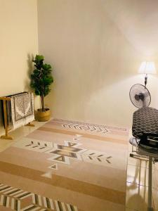 a living room with a chair and a rug at Ila Homestay in Senawang