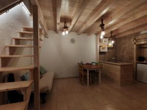 a room with a staircase and a table and a kitchen at Dimora Fajano in Fasano