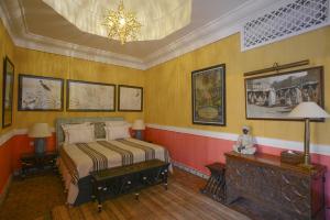 a bedroom with a bed and a chandelier at DAR ELHADIR in Tozeur +13 photos
