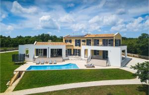 a large house with a swimming pool in front of it at Villa Arkaim in Pula