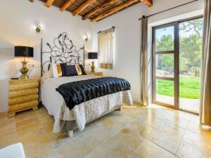 a bedroom with a bed and a large window at Holiday home with children play area in Santa Eularia des Riu +31 photos