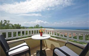 a balcony with a table and chairs and the ocean at Amazing Home In Makarska in Makarska