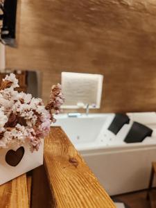 a bathroom with a bath tub and a vase of flowers at Dimora Fajano in Fasano +48 photos