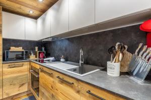 a kitchen with a sink and a counter top at HelloCHALET - Casa Val - Your Walking Distance holiday in Valtournenche +14 photos