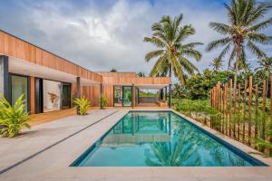 a swimming pool in the backyard of a house at Pacific Palms Luxury Villa in Rarotonga