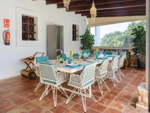 Un comedor con una mesa larga y sillas. en Villa in San Rafael with Private Pool, en Sant Rafael