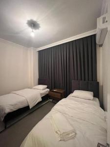 a hotel room with two beds and a ceiling fan at One Suit in Kartepe