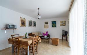a dining room and living room with a table and chairs at Beautiful Apartment In Premantura in Premantura