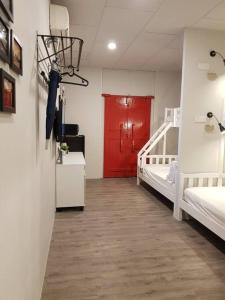 a room with two beds and a red door at Heritage Studio in UNESCO Zone near to StreetArt & Town 1 in George Town +11 photos