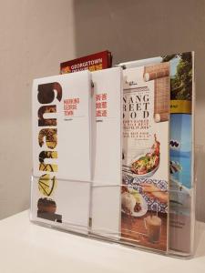 a group of books sitting on top of a refrigerator at Heritage Studio in UNESCO Zone near to StreetArt & Town 1 in George Town