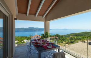 a table on a balcony with a view of the water at Villa Istra Panorama in Opatija