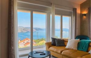 a living room with a couch and a large window at Villa Istra Panorama in Opatija
