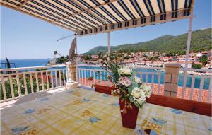 a table with a vase of flowers on a balcony at 4 Bedroom Beautiful Apartment In Brna in Brna