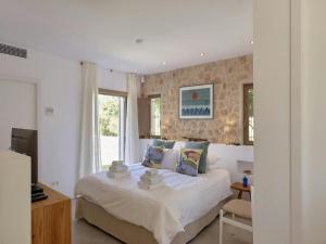 a bedroom with a bed and a window at Holiday Home Ibiza near Cala Tarida Beach in Sant Josep +32 photos