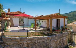 a house with a patio and a stone wall at Beautiful Home In Golovik With Wifi in Martina