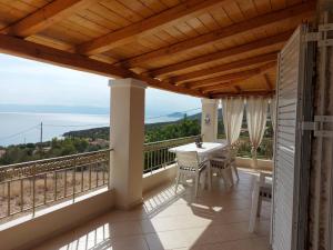 a balcony of a house with a table and chairs at Holiday House Sonia in Didyma