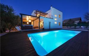 a swimming pool in front of a house at night at Villa Suncica in Sukošan +53 photos