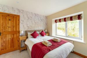 a bedroom with a bed with two towels on it at Lakes Cottage in Backbarrow