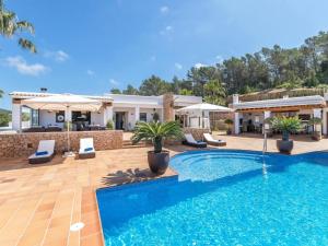 a villa with a swimming pool and a house at Villa in Santa Gertrudis with Infinity Pool in Santa Gertrudis de Fruitera