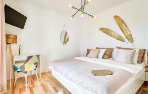 a white bedroom with a bed and a desk at Villa Suncica in Sukošan