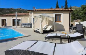 a patio with a gazebo and a swimming pool at Awesome Home In Starigrad Paklenica in Starigrad-Paklenica +44 photos