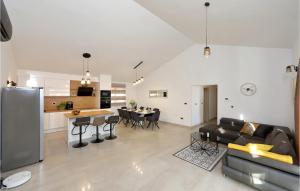 a living room and kitchen with a couch and a table at Awesome Home In Starigrad Paklenica in Starigrad-Paklenica