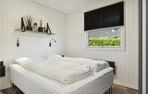 a white bed in a room with a window at Stunning Home In Bogense With Wifi in Bogense +15 photos